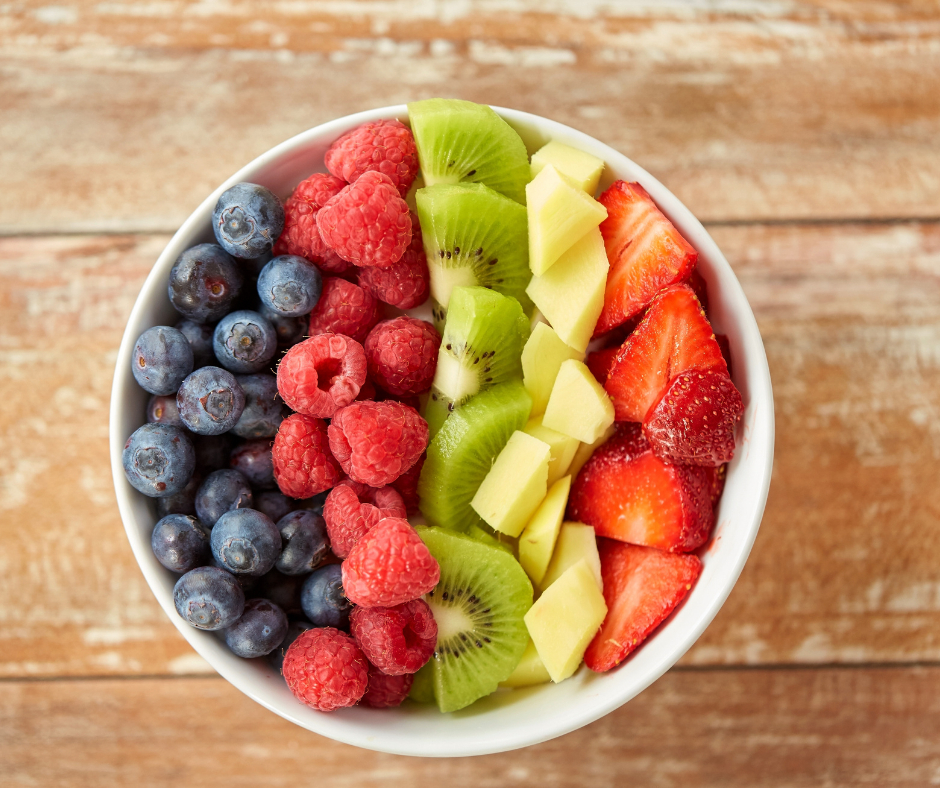 A light and healthy fruit bowl with blueberries, raspberries, kiwi, pineapple and strawberries.
